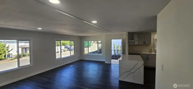 Spacious Living room looking North towards Front Entrance with kitchen on the left