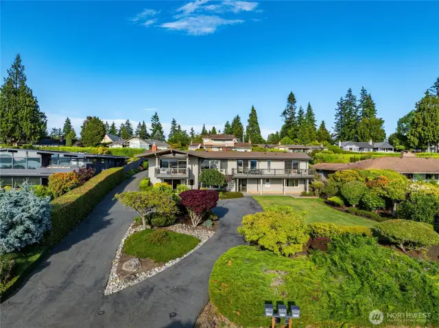 An aerial view showing the manicured landscaping and plenty of off-street parking.
