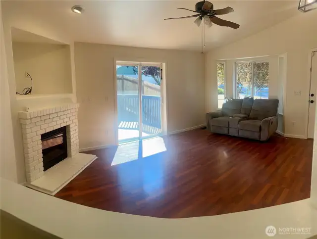 Hardwood floors, gas fireplace and sliders out to the new deck