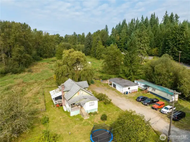 Classic 1920 homestead Farmhouse on 7.36 acres. Hip roof barn, garage/shop and updated Manufactured home