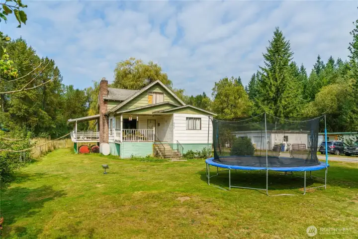 Frontal home view with shop and Manufactured home in the background