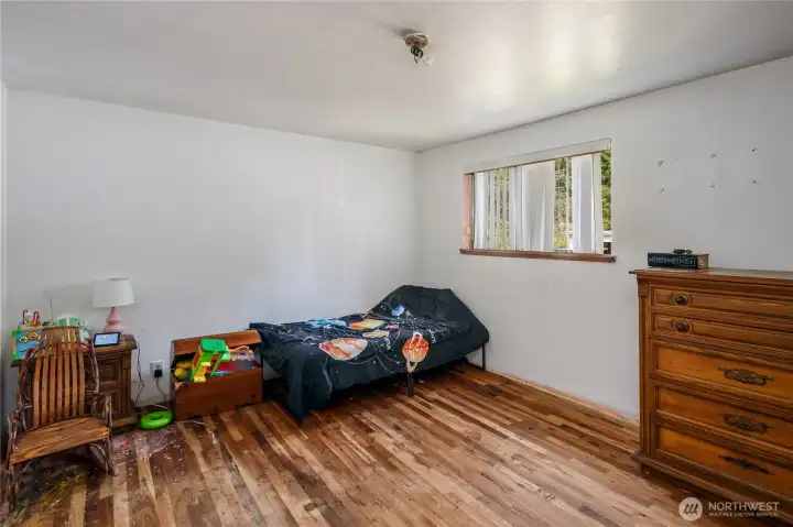 main floor bedroom with natural hardwood flooring