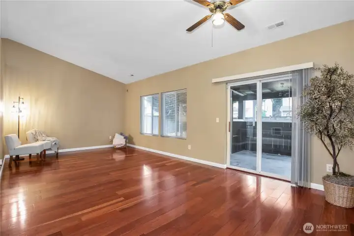 The slider just off of the the living room takes you to a covered porch that is screened in