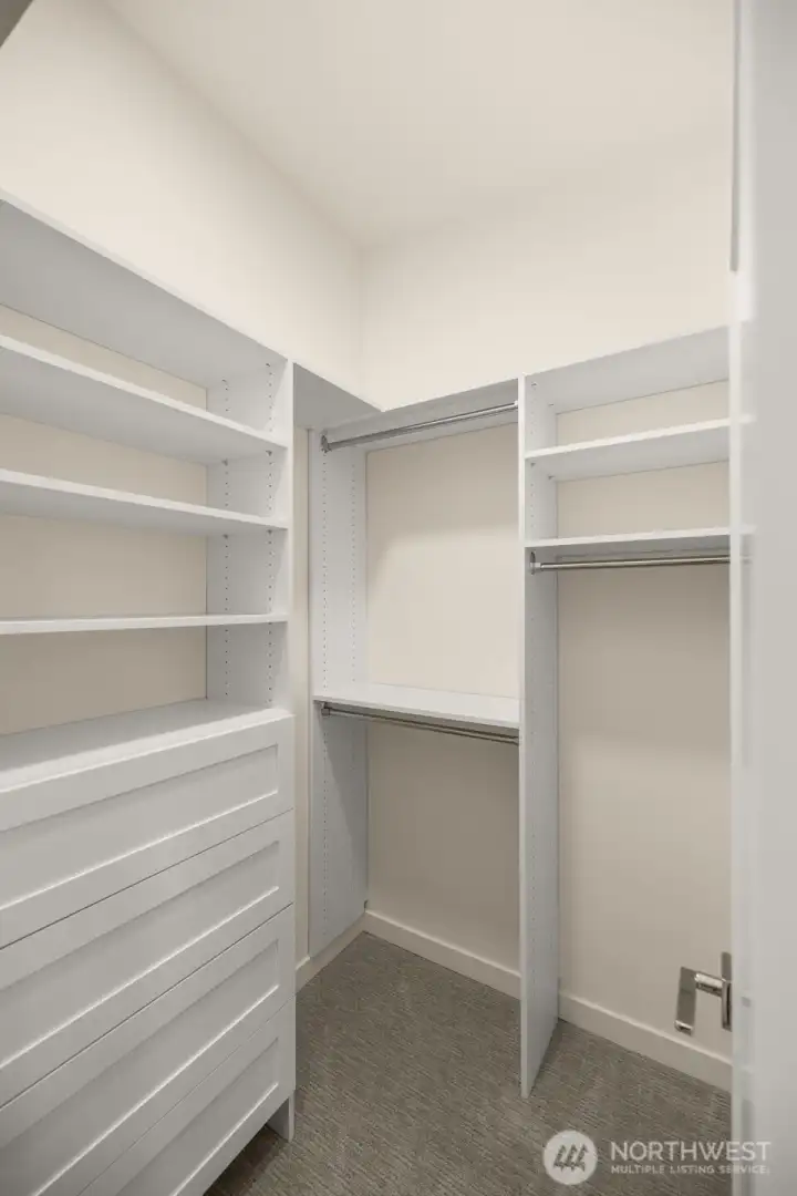 This thoughtfully designed walk-in closet offers ample shelving and hanging space to keep your wardrobe organized and accessible.Photos of home with similar layout, finishes & fixtures.