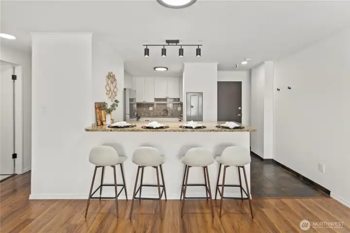 Beautifully updated modern kitchen with granite counters and extra large eating nook.That flows with east to your living space.