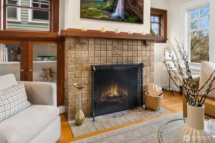 Stately Batchelder-tiled gas fireplace anchors this room with a cozy focal point.