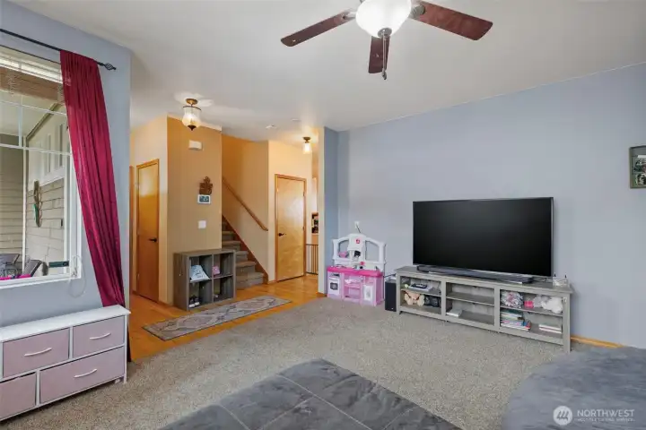 Living room and two closets for abundant storage. Note: one leads to open storage under the stairs.