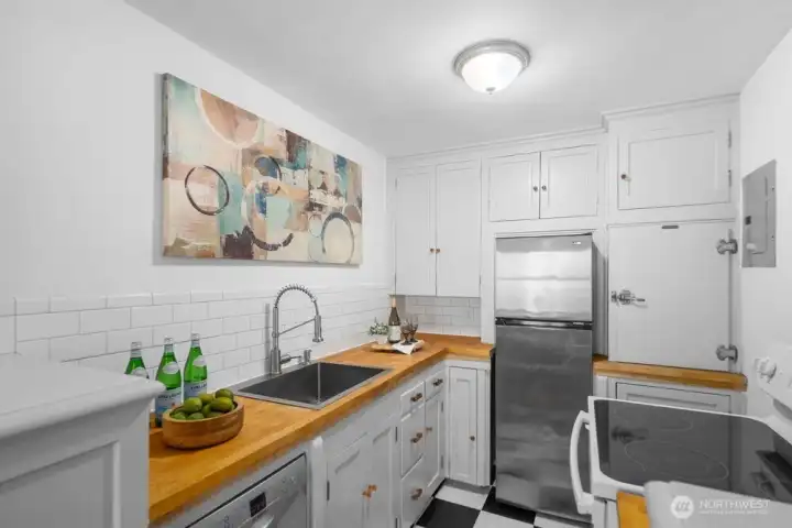 woodblock countertops and stainless appliances await you in this kitchen space