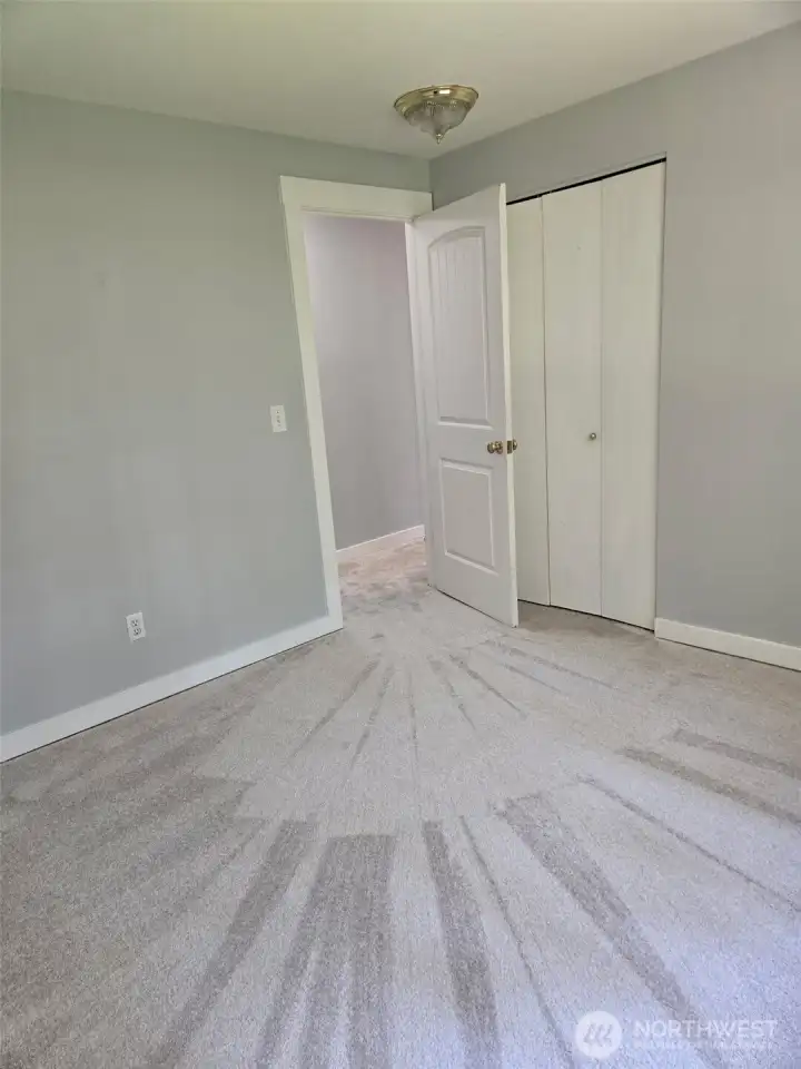 Fresh, neutral tones and plush carpet make this upstairs bedroom move-in ready. The room includes a standard closet and clean white trim, perfect for guests, a nursery, or a home office.