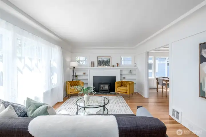 A cozy fireplace and beautiful built-in shelves create a warm, welcoming focal point for this bright room. A cozy fireplace and beautiful built-in shelves create a warm, welcoming focal point for this bright room.