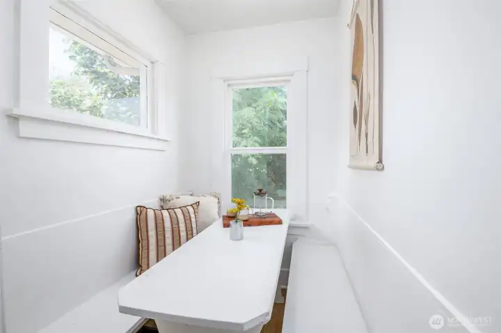 This kitchen features a cozy built-in breakfast nook, perfect for morning coffee or gathering with friends while you cook. This kitchen features a cozy built-in breakfast nook, perfect for morning coffee or gathering with friends while you cook.