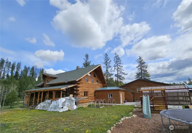 Back of house with more wood storage and gardening space close to play area