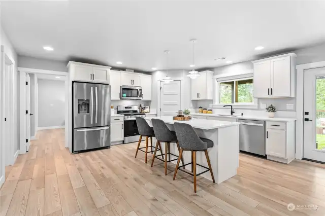 Updated kitchen with solid surface countertops and large pantry.