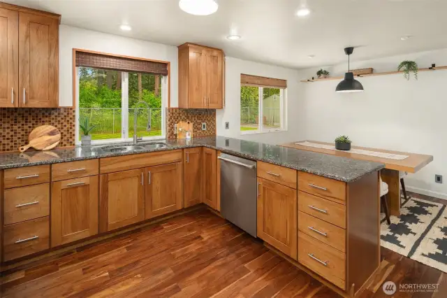 Slab granite counters & Thomasville cabinets with soft close and additional pull out storage.