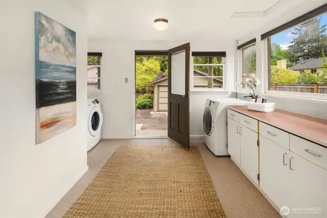 The mud/laundry room is light/bright and has doors to the kitchen, front driveway, and backyard.