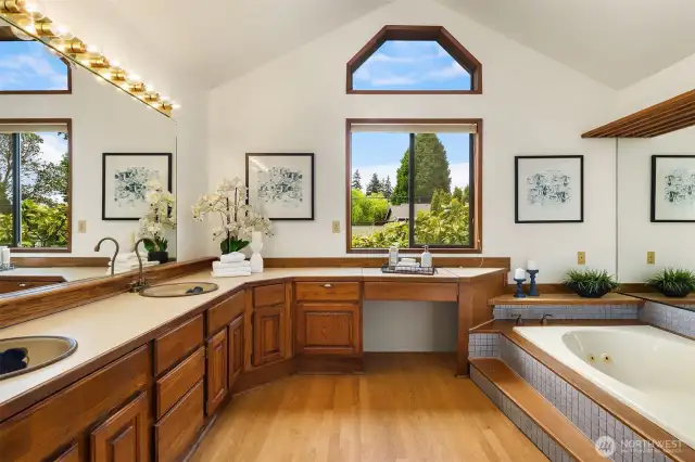 The primary bath has vaulted ceiling, duel sinks, makeup area, hardwood floors, tub & shower.