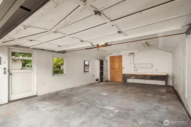 Spacious garage with workbench and storage space.
