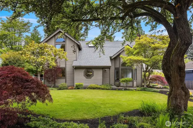 Charming curb appeal with manicured lawn and beautiful trees.