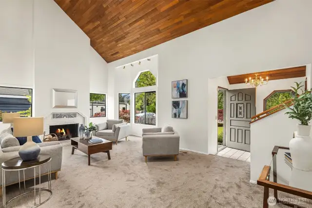 Living room with fireplace, large windows, and fireplace (buyer to verify functionality of fireplace - fire added to photos for appeal)