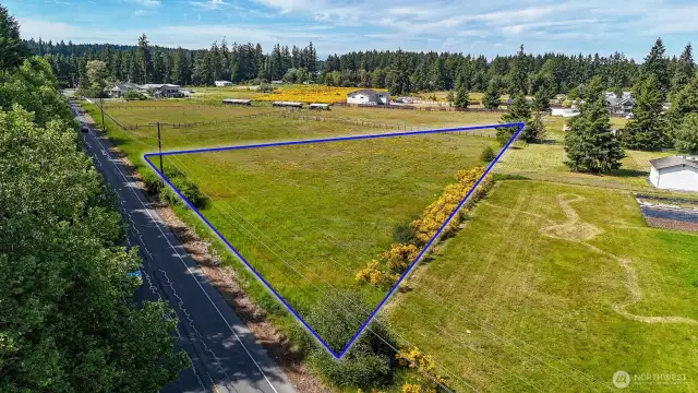2.03 acres of level land, ready for development. Blue boundary lines are approximate. Buyer to verify to their own satisfaction.