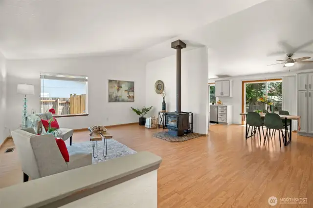 Front entry way looking into living room with large windows and wood burning stove