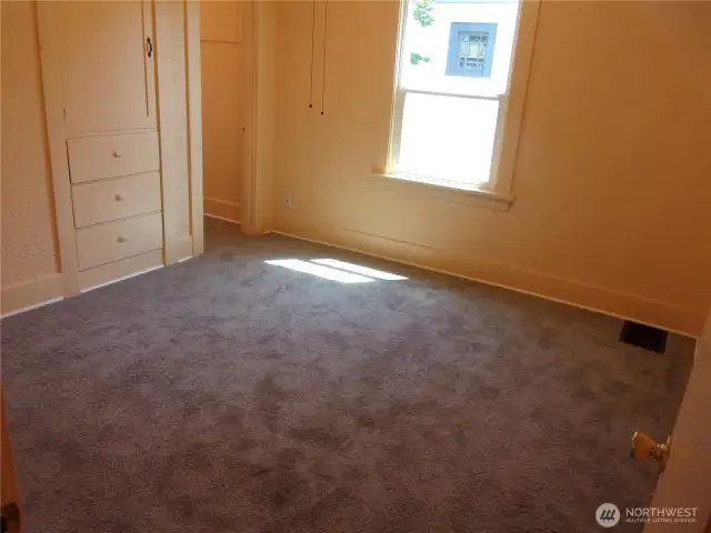 Primary bedroom on the main floor features new carpet and fresh paint.