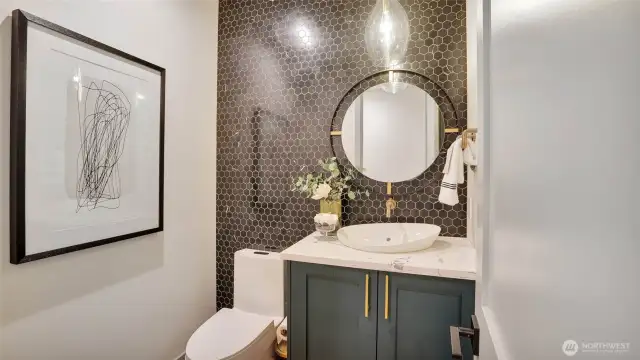 Stunning main floor powder room with exquisite tile detail and floating sink.