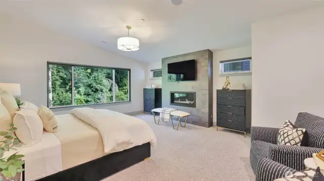 Upstairs, the primary suite is a private sanctuary with floor-to-ceiling fireplace, overlooking the peaceful forest.