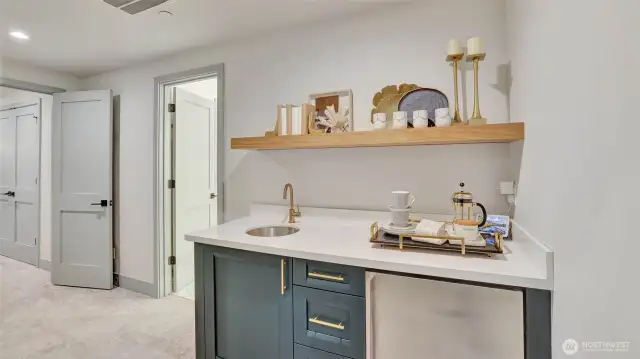 Primary retreat includes a personal beverage bar with ambient lighting, sink, and refrigerator. Morning coffee is just steps away!