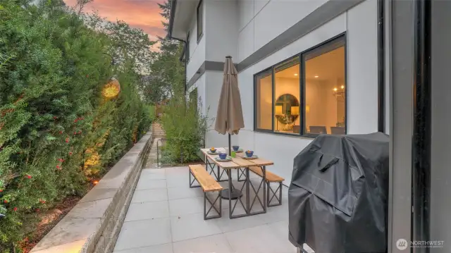 Private dining area, adjacent to the covered patio, complete with BBQ and pizza oven, offers additional space for al fresco dining and summer fun.