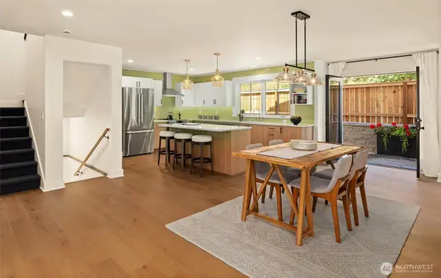 Dining and kitchen area offer optimal spacing with this open concept design. Walk-out patio with double French doors flood the main space with sunlight and air....