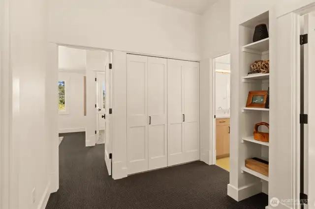 Built in shelving frames an open landing at the upstairs bedroom entrances. Utility laundry closet upstairs for convenient access.