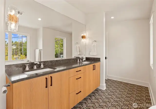 Double sinks with custom light sconces with heated floors.