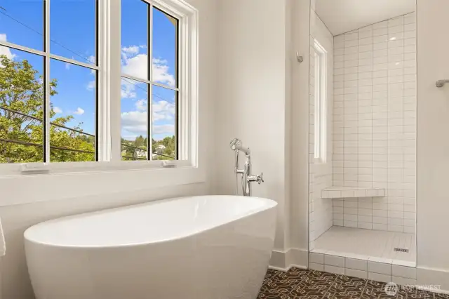 Separate soaking tub in spacious primary suite.