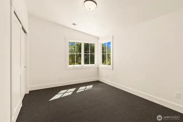 SE corner guest bedroom upstairs with vaulted ceilings.