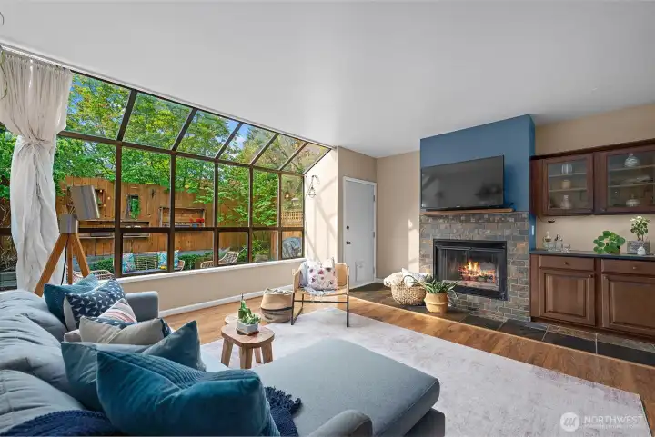 Open, spacious, and tranquil living space with wood burning fireplace.