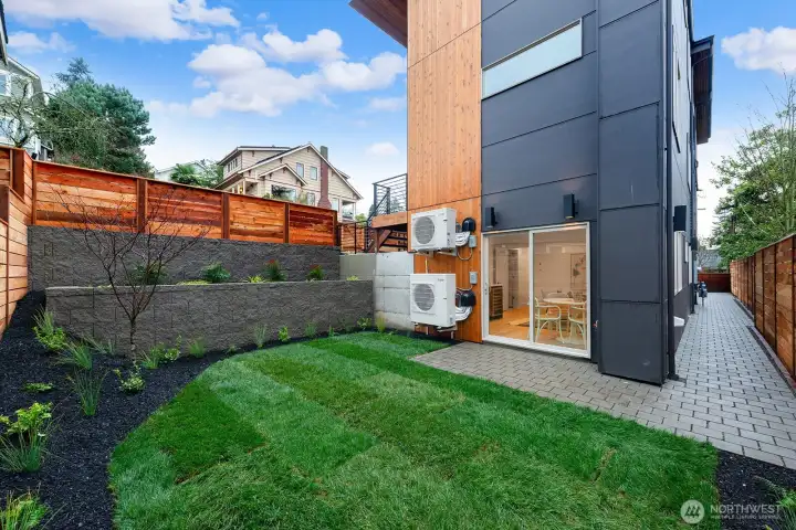 Yard space off the ADU / media or rec room. The patio is plumbed for a gas BBQ. Access to the ADU via the pathway on the right.