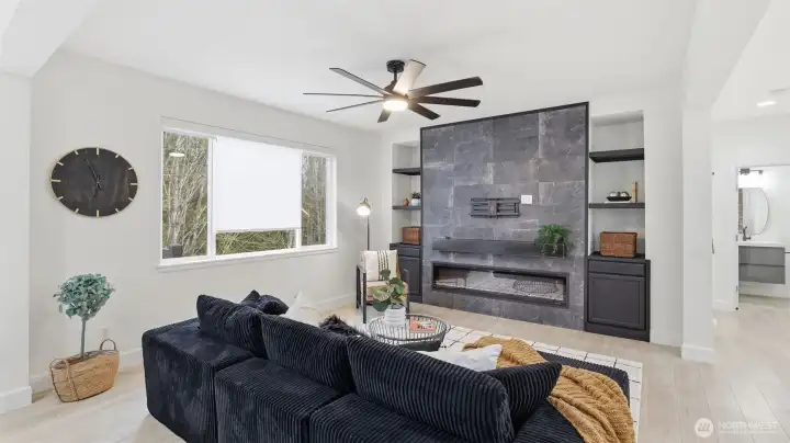 Open living space anchored by a stunning fireplace feature wall.