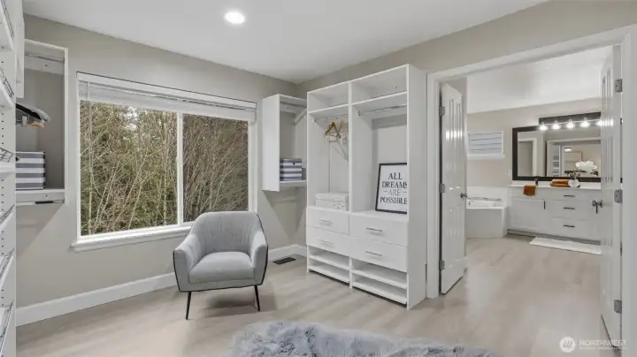 Expansive walk-in closet with custom shelving and direct access to the primary bath.