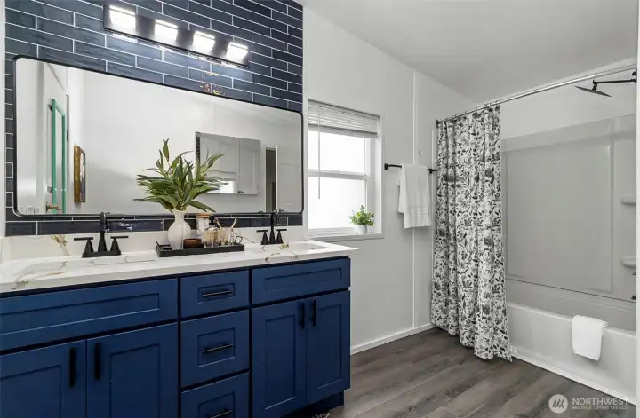 Main Bath is very spacious - quartz coutertop with tile acccent.