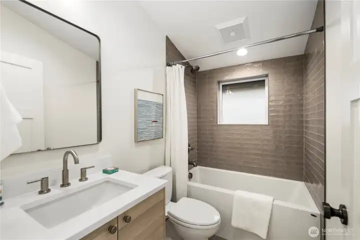 Extra deep soaking tub with full tile surround