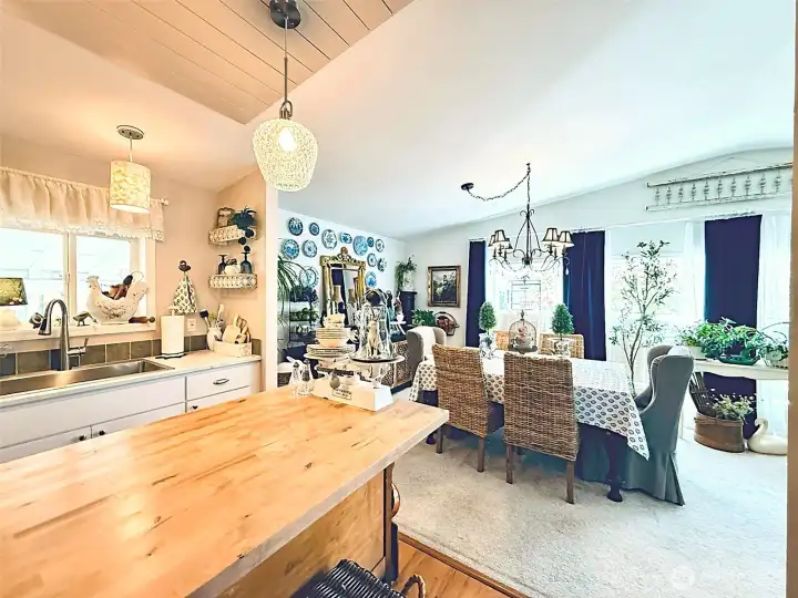 View from  updated kitchen into the dining room, LVP in kitchen, island, updates throughout home