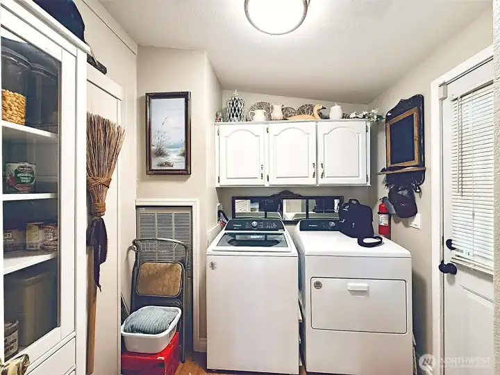 Laundry room with pantry storage, door leads to covered parking and bonus covered private patio and storage outbuilding, easy access to landscaped backyard