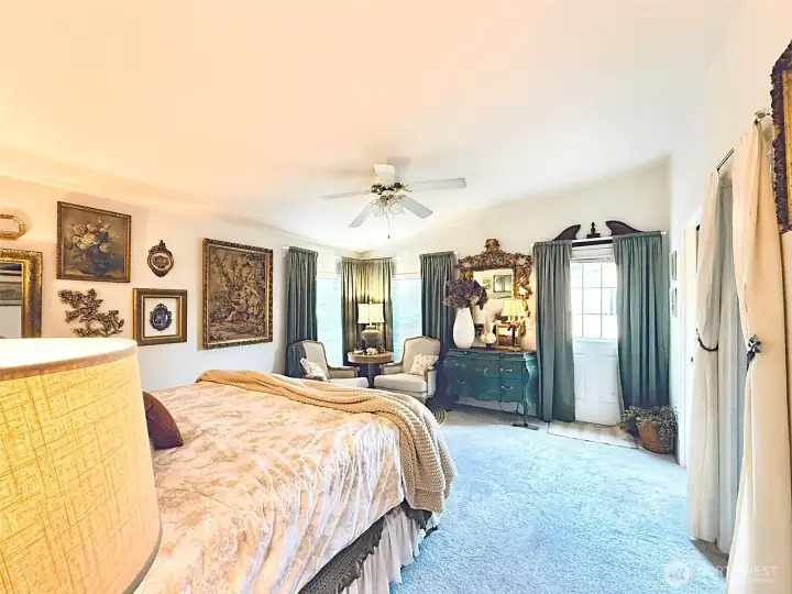 Primary bedroom view from hallway, access to backyard and deck, space for sitting area, walk-in closet with organizers