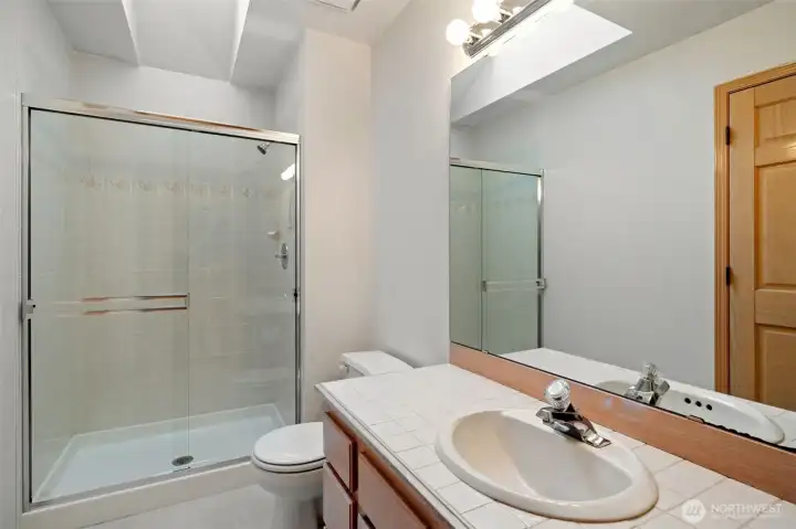 Main Hallway Bathroom with stall shower and fresh flooring.