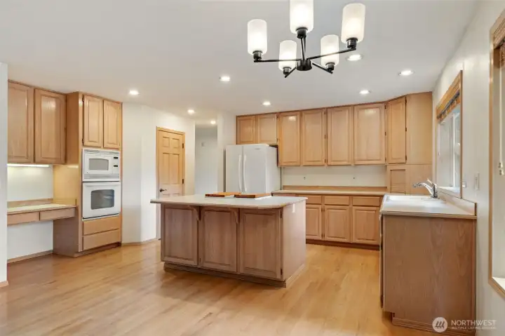 Kitchen - without virtual staging. Wood floors & new lighting.