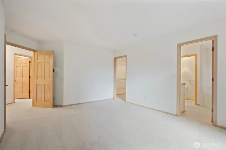 Primary Bedroom - fresh carpets and french door entry - shown without virtual staging