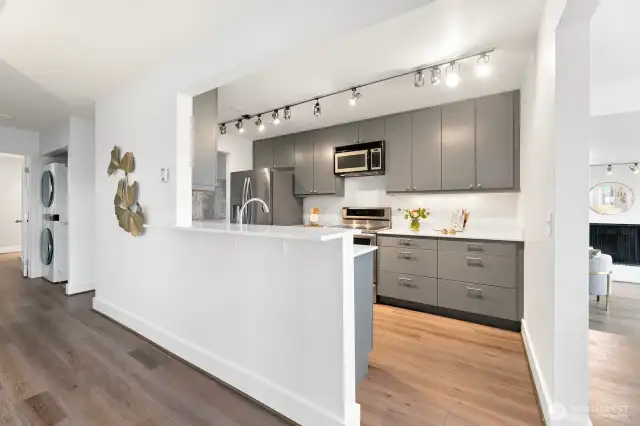 Updated kitchen counters, plenty of light and IN UNIT FULL SIZED LAUNDRY tucked down the hall