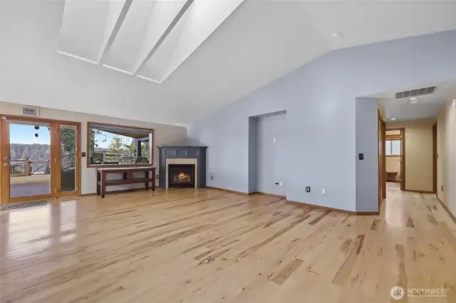 Skylights, beautiful hickory wood floors, and fireplace are featured in the living room.