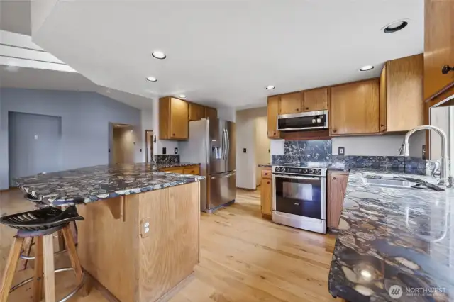 Kitchen features gorgeous granite counters, plenty of cabinet space, and eat-in-bar.